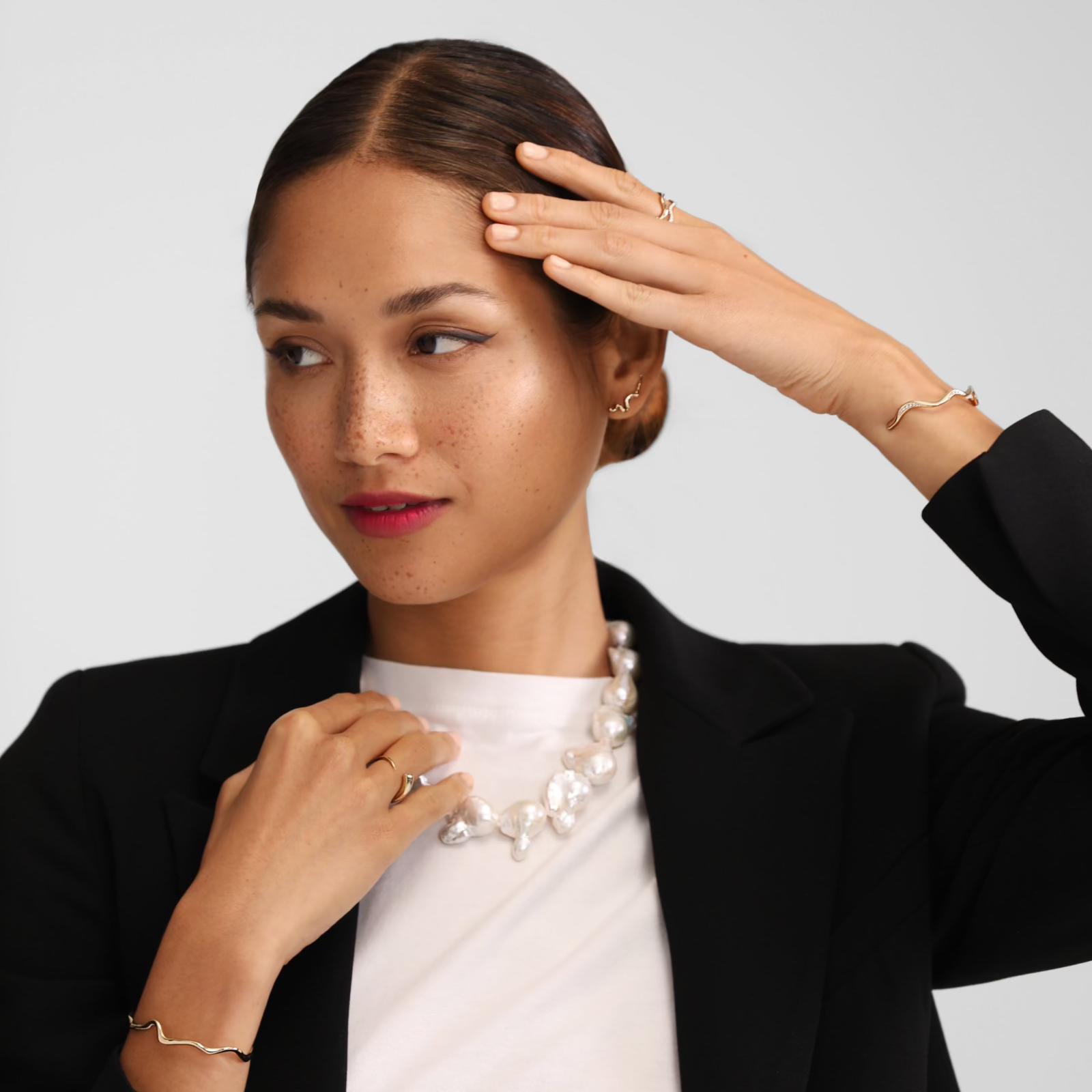 Baroque Pearl Collar on model in White Tee with black blazer and ripple bracelets.