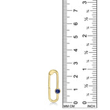 14K yellow gold charm lock with a sapphire stone, set against a ruler for scale, on a white background.