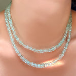 2 tiered strands of AMANDA PEARL faceted aquamarine rondelle necklaces on a model's neck.