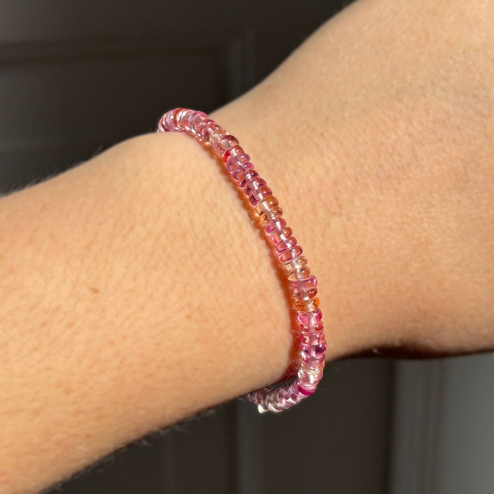 AMANDA PEARL Hibiscus padparadscha sapphire beaded bracelet on a model's wrist.