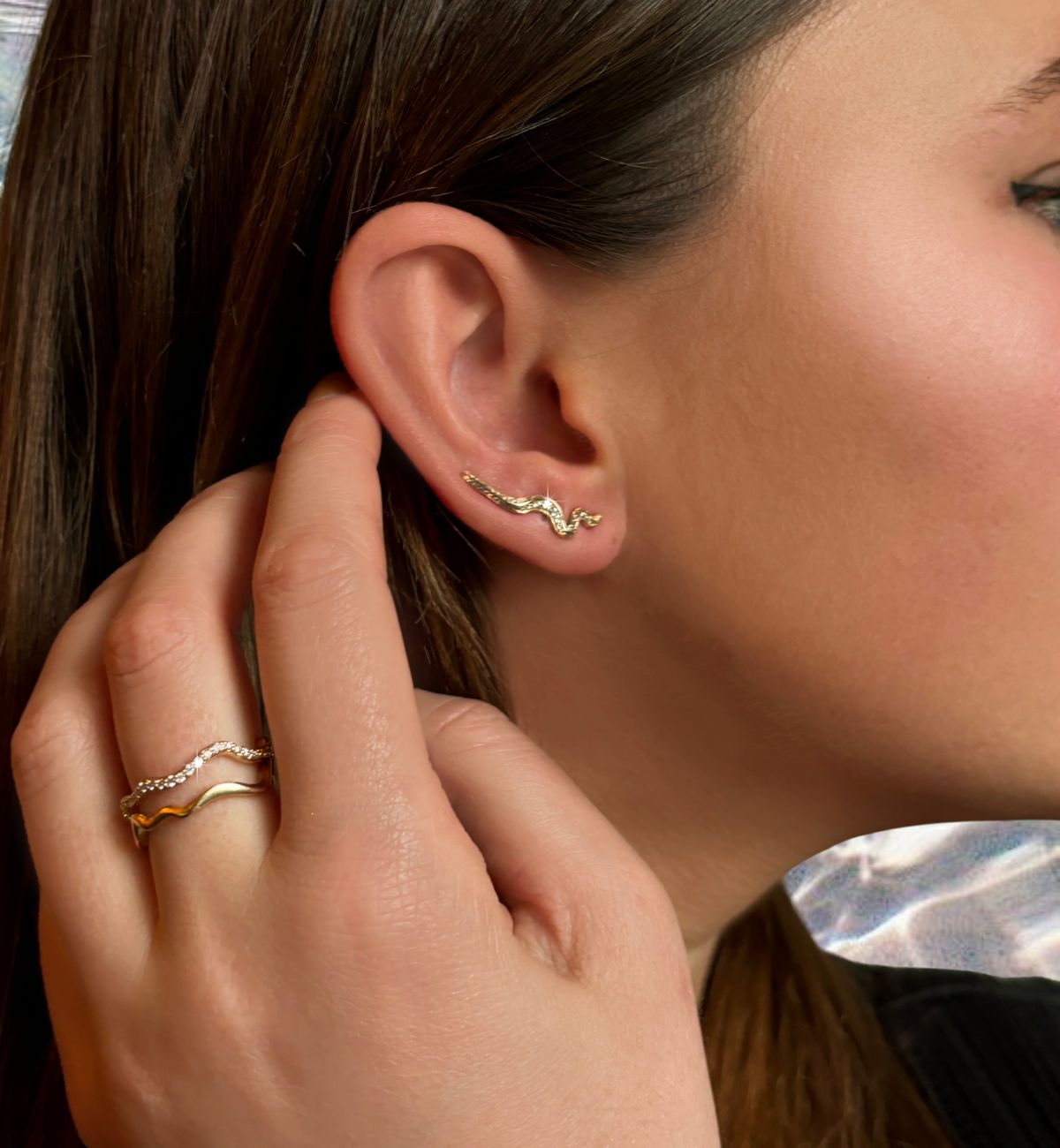 recycled 14k gold and cultivated ripple climber earrings and ripple rings on a model.