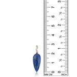 Long Lapis Drop Charm with white gold ripple bale on a white background next to a ruler.