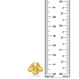 A ring in the shape of a rounded, stylized skull cast in 14k recycled yellow gold sits alongside a ruler demonstrating that the skull is 13mm high.