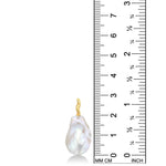 An AMANDA PEARL medium white baroque pearl against a ruler showing it's height to 29mm tall. It has a unique 14K recycled yellow gold ripple bale. 