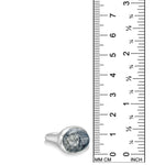A recycled sterling silver ring with an oval rutilated quartz cabochon gemstone, shown next to a black ruler with millimeter and inch markings to indicate its size.