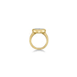 side view oval molten diamond solitaire ring in yellow gold against a white background
