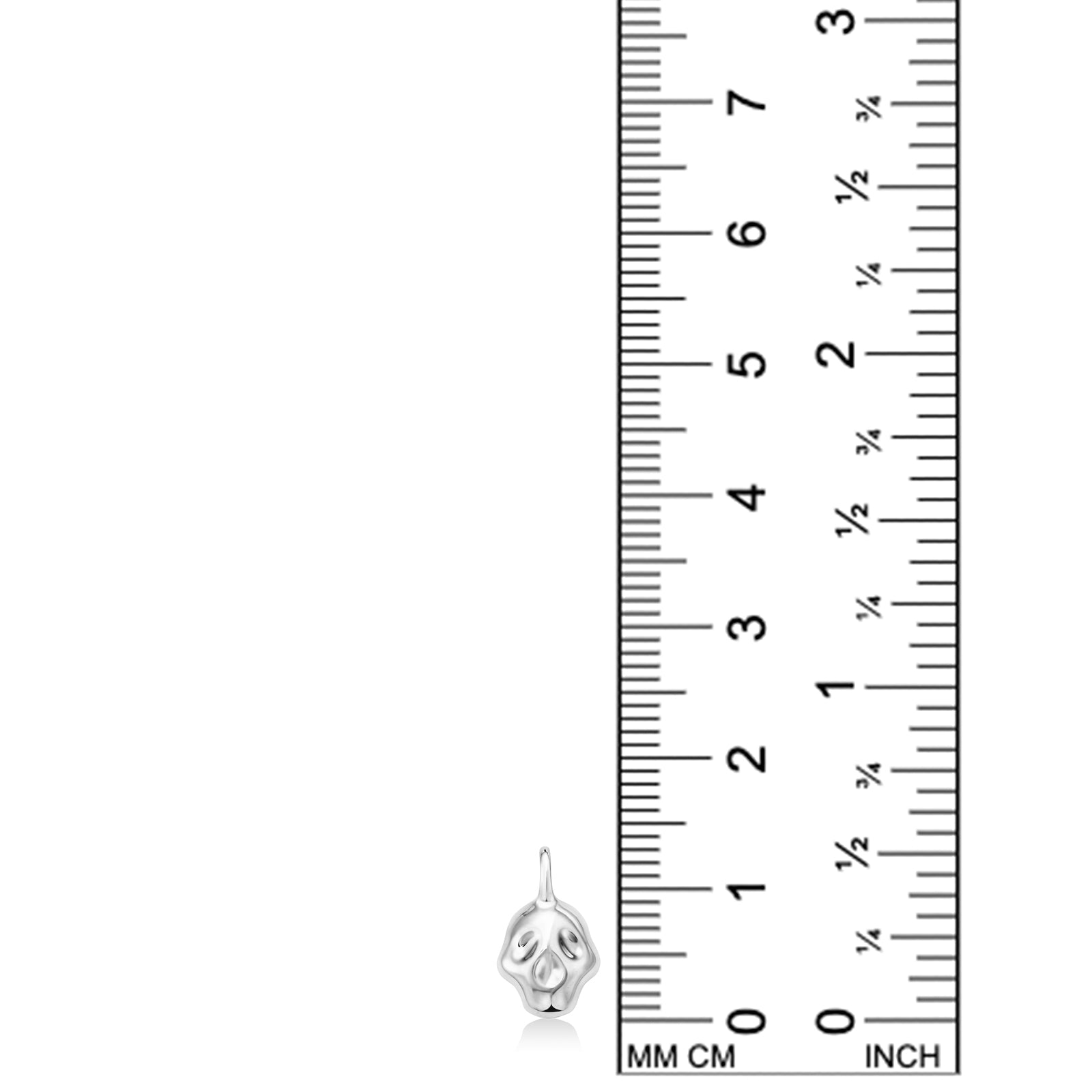 AMANDA PEARL Molten Skull Charm in recycled sterling silver on a white background next to a ruler.