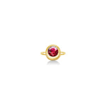 Molten solitaire ring in recycled 14k yellow gold with a round, cultivate ruby on a white background. 