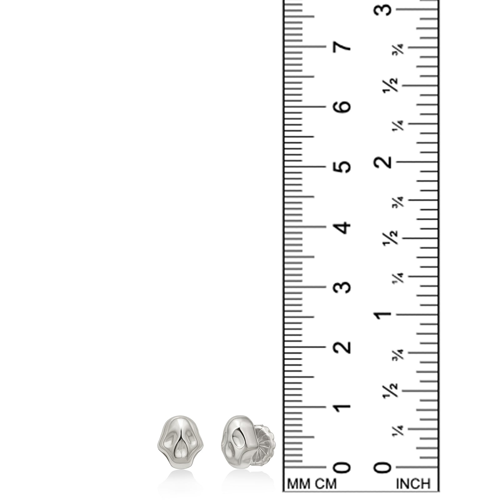 AMANDA PEARL Molten skull studs in recycled sterling silver on a white background next to a ruler.