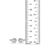 White Gold Molten Studs with diamond pavé on a white background next to a ruler.