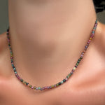 A single multi tourmaline necklace on a model's neck.