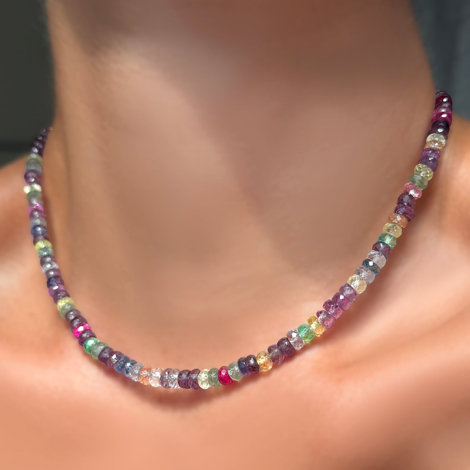 A 16" strand of night fever faceted sapphires on a model's neck.