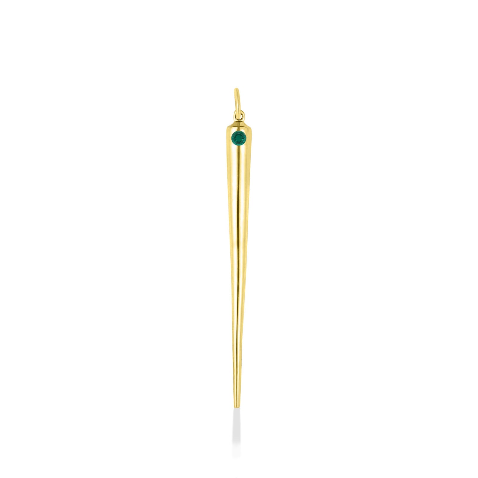 A quill spike charm cast in recycled yellow gold with a bezel set lab grown emerald, on a white background. 