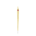 A quill spike charm cast in recycled yellow gold with a bezel set lab grown ruby, on a white background. 