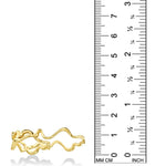 A 14K recycled yellow gold double finger ring, with an undulating irregular shape inspired by ripples in water against a ruler showing its height to be 15mm.