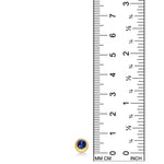 A round molten solitaire earring in 14K yellow gold with a bezel set sapphire, set against a ruler for scale on a white background.