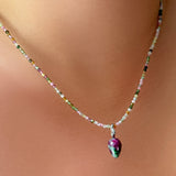 Ruby Zoisite Drop Charm and tourmaline slim gemstone necklace on the neck.