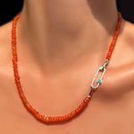 An AMANDA PEARL faceted carnelian necklace on a recycled sterling silver evolution clasp holding a recycled sterling silver paperclip charm lock with turquoise cabochon.