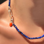 Faceted lapis rondelles on a sterling silver evolution clasp holding a paperclip charm lock with carnelian cabochon, holding a carnelian drop charm with sterling silver ripple bale.