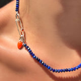 Faceted lapis rondelles on a sterling silver evolution clasp holding a paperclip charm lock with carnelian cabochon, holding a carnelian drop charm with sterling silver ripple bale.
