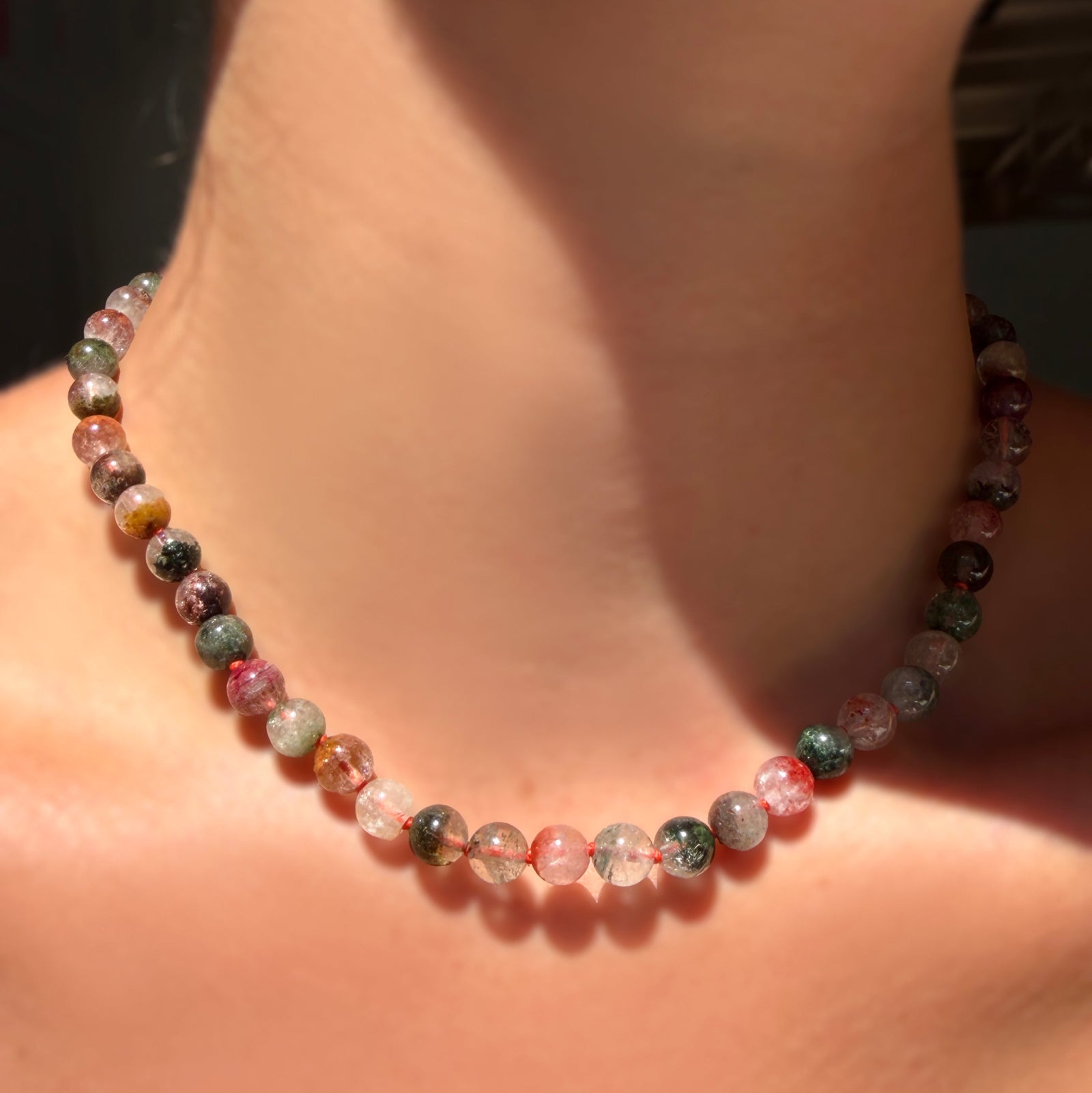Phantom Quartz Necklace on carnelian thread on a model's neck.