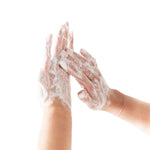Hands with soap bubbles on a white background