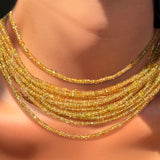 Solar yellow faceted sapphire necklaces layered on a model's neck.