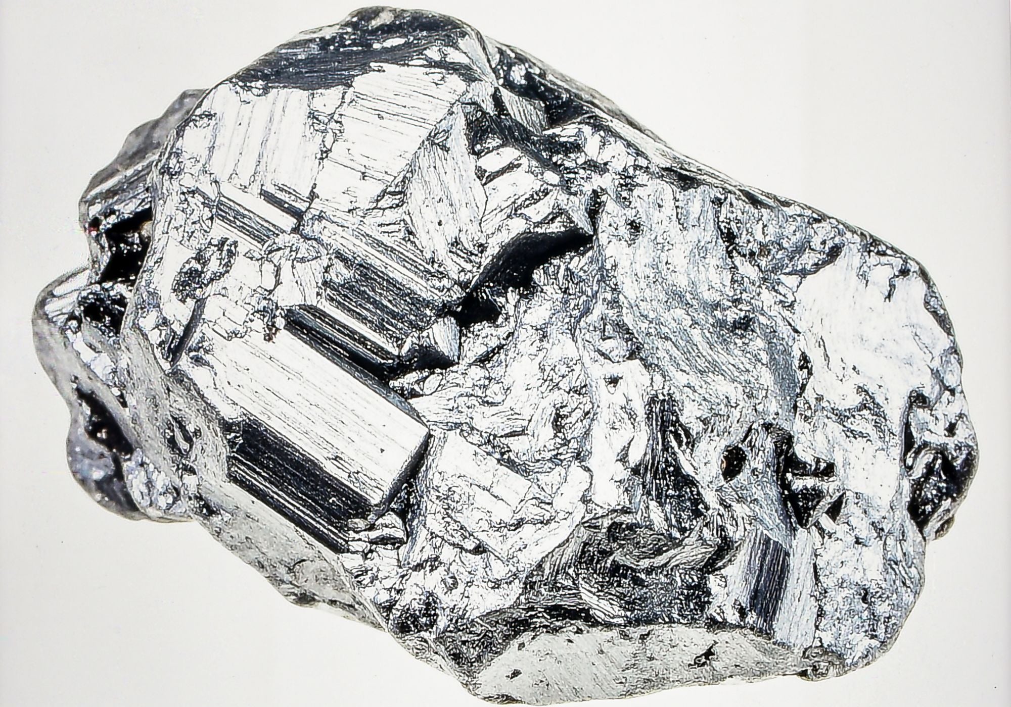 Chunk of raw silver ore on a white background.