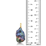 AMANDA PEARL Storm blue/purple/peacock baroque pearl with a white gold ripple bale on a white background next to a ruler.