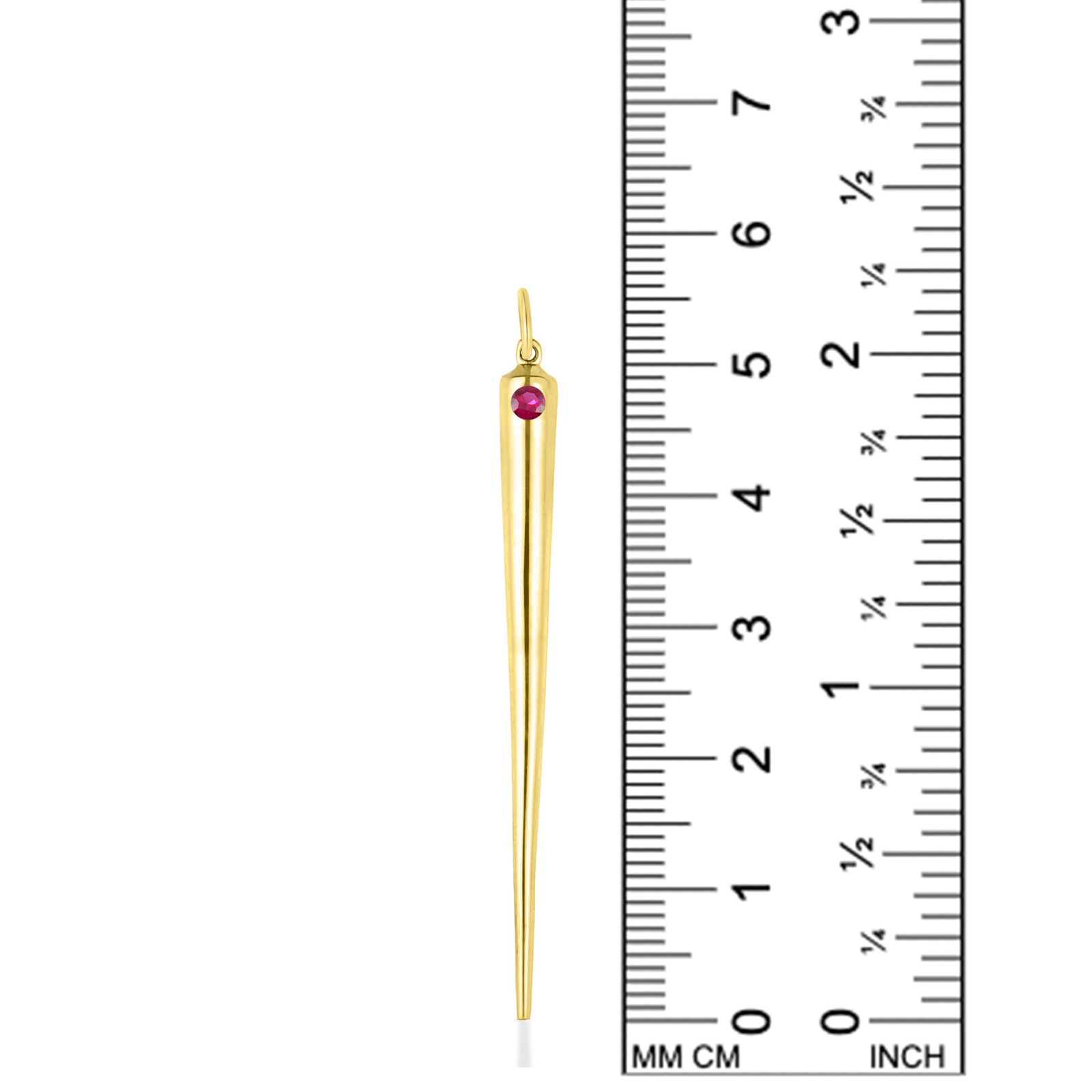 A quill spike charm from AMANDA PEARL in 14K recycled yellow gold with ruby sits against a ruler for scale.