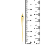 A quill spike charm from AMANDA PEARL in 14K recycled yellow gold with sapphire sits against a ruler for scale.