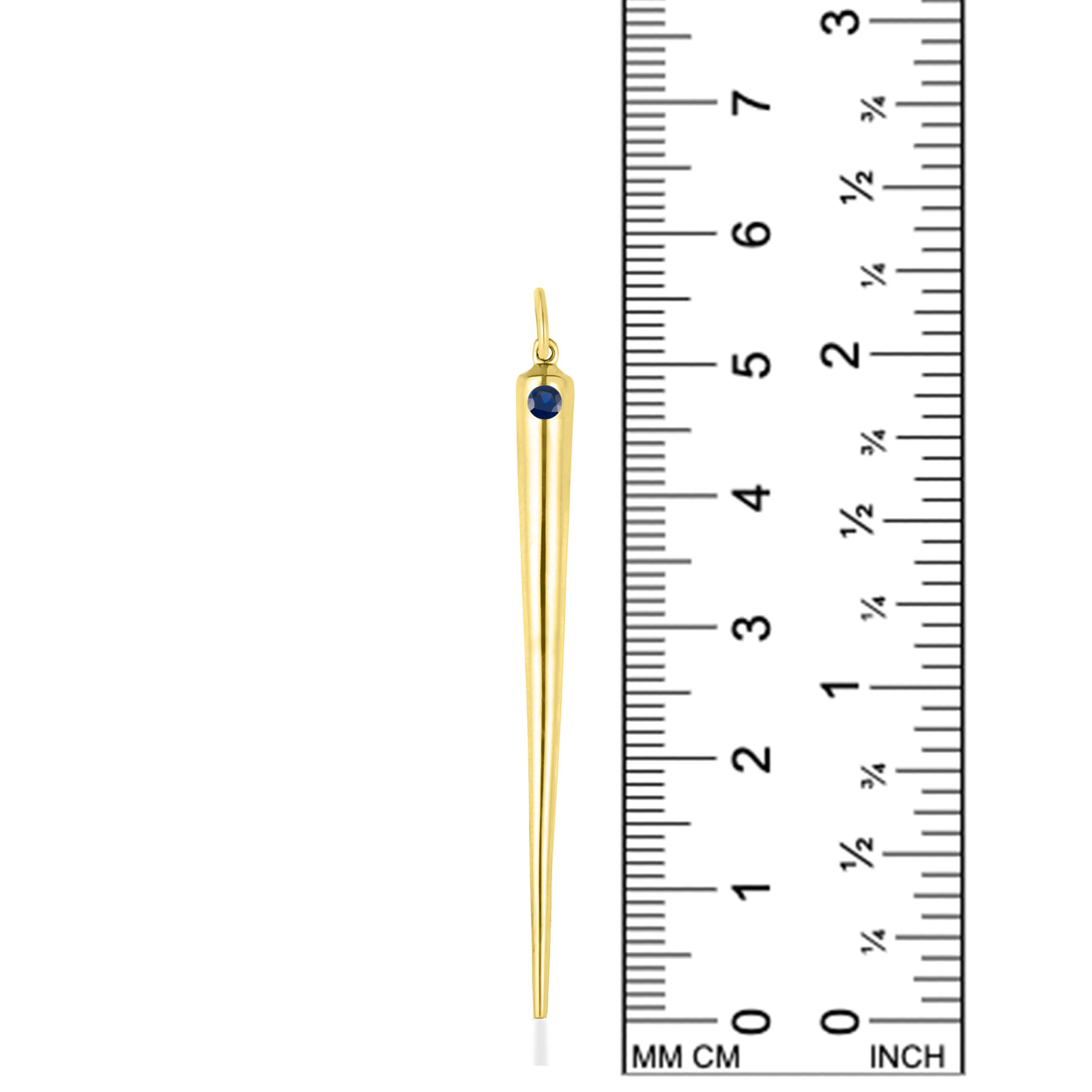A quill spike charm from AMANDA PEARL in 14K recycled yellow gold with sapphire sits against a ruler for scale.