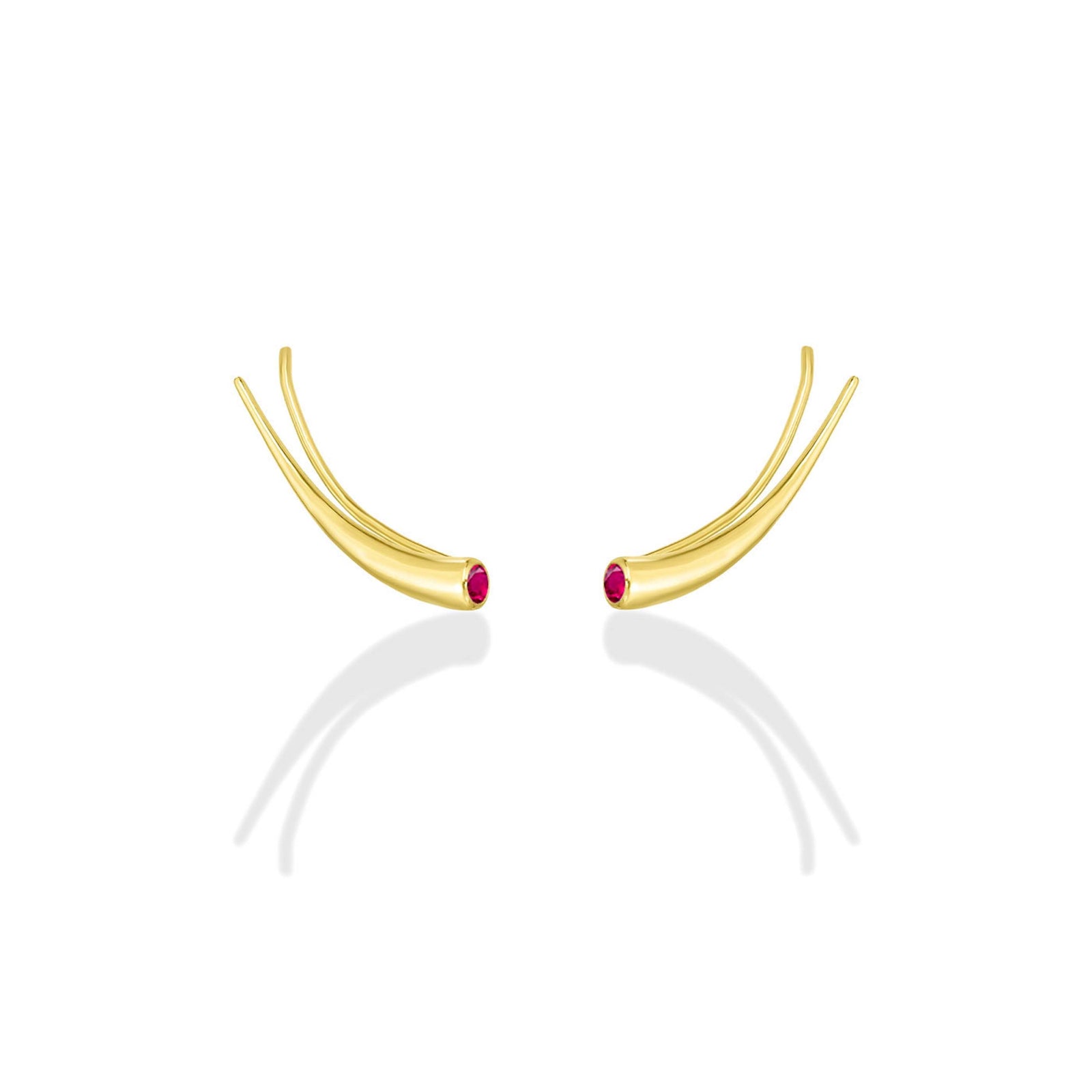 A pair of 14k recycled yellow gold climber earrings with a quill spike shape and a bezel set round ruby on a white background