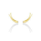 A pair of 14k recycled yellow gold climber earrings with a quill spike shape and a bezel set round diamond on a white background.