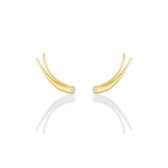 A pair of 14k recycled yellow gold climber earrings with a quill spike shape and a bezel set round diamond on a white background.