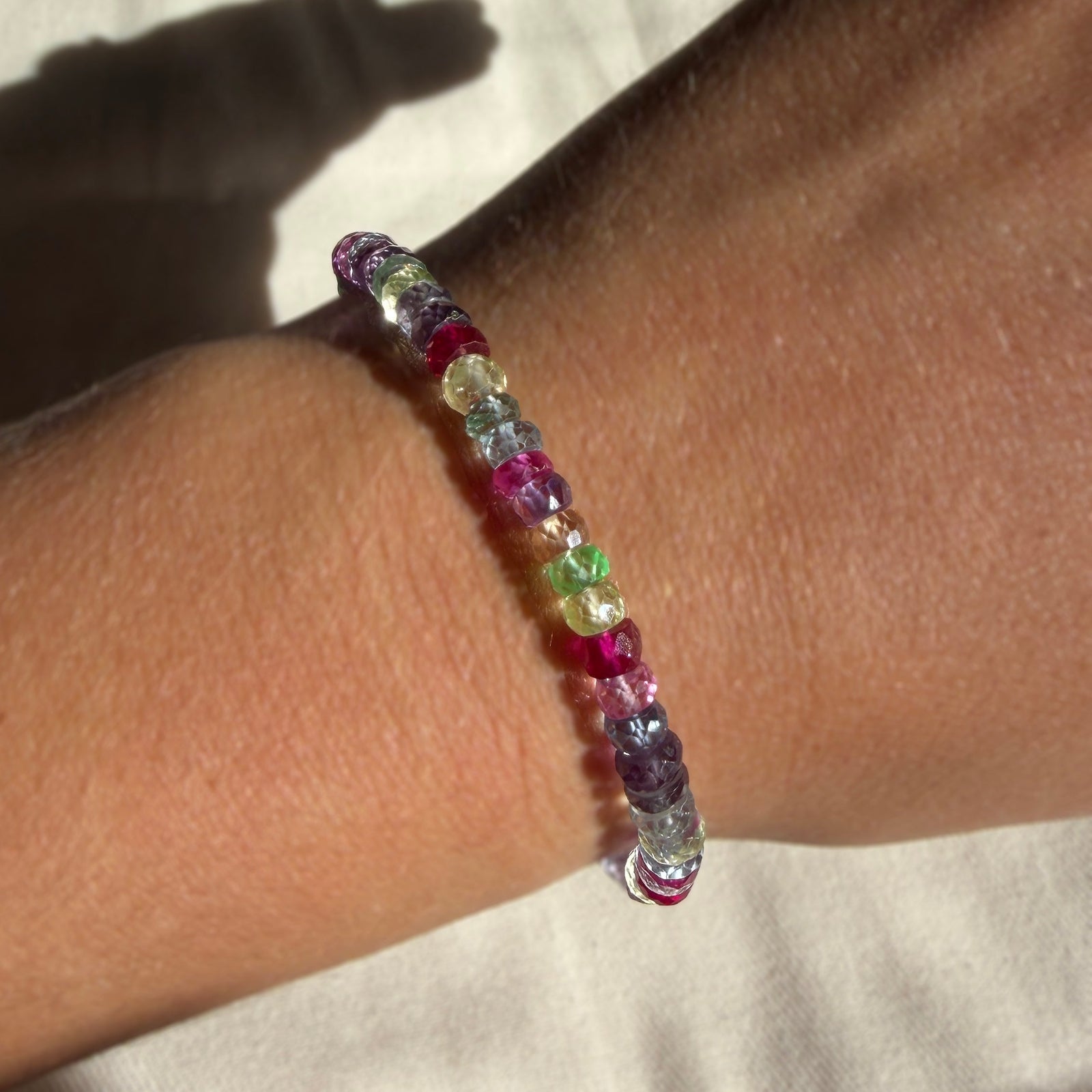 Night fever faceted sapphire bracelet on a model's wrist.