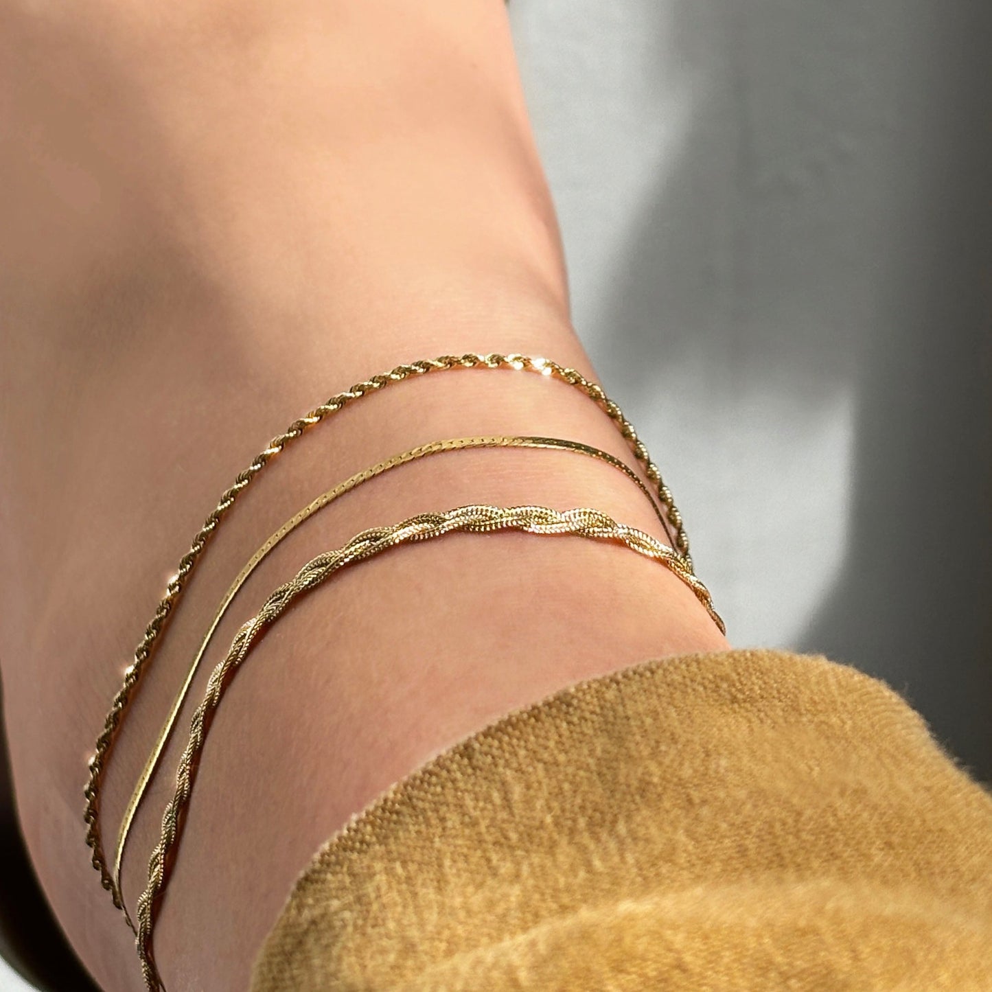 14k gold Braided Fox Chain Anklet styled on an ankle