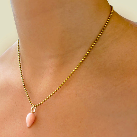 Peruvian pink opal acorn drop charm. Styled on a neck hanging from the bead chain necklace. 