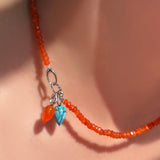 Faceted carnelian necklace with carnelian and turquoise drop charm in the linking ovals clasp.