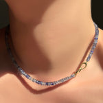 Denim blue faceted sapphire necklace with linking ovals clasp to the front.