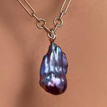 Irregular chain necklace with storm blue baroque pearl charm on a recycled 14k gold ripple bale.