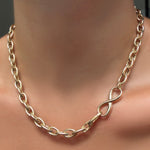 An AMANDA PEARL Drop Link Chain Necklace with Molten Infinity Charm Lock in the clasp.