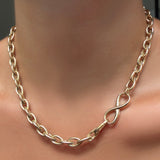 An AMANDA PEARL Drop Link Chain Necklace with Molten Infinity Charm Lock in the clasp.