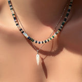 Double shade faceted welo opal necklace layered on the neck with white gold diamond cut bead chain and moonstone drop charm.