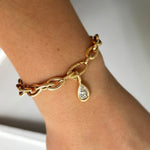 AMANDA PEARL Drop Link chain bracelet with molten solitaire charm with pear diamond in recycled 14k yellow gold.