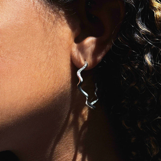 14k white gold Demi Pavé Ripple Hoop Earring styled on an ear