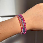 AMANDA PEARL Hibiscus sapphire beaded bracelets stacked on a model's wrist.