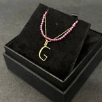 Purple garnet slim gemstone necklace with a diamond cut bead chain with letter G charm bundled in a black gift box.