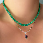 grass green faceted opal necklace layered with tourmaline slim gemstone necklace and Ruby Zoisite Drop Charm on the neck.