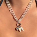 3 strands of herkimer diamond beads with white gold and diamond pavé charm locks hanging three charms.